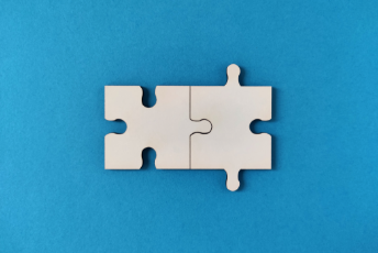 blue background with two fitting white puzzle pieces