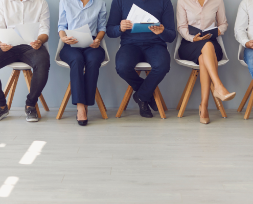 five workers waiting for a job interview