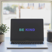 be kind in green and blue on laptop screen