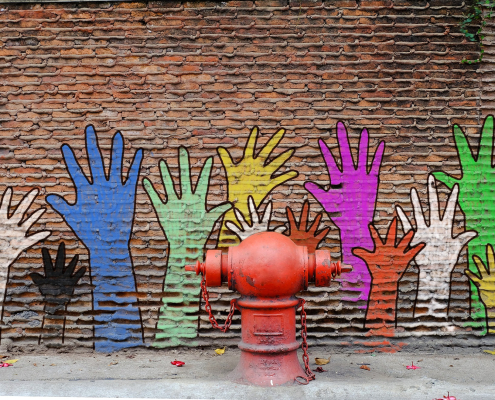 hand mural on brick wall