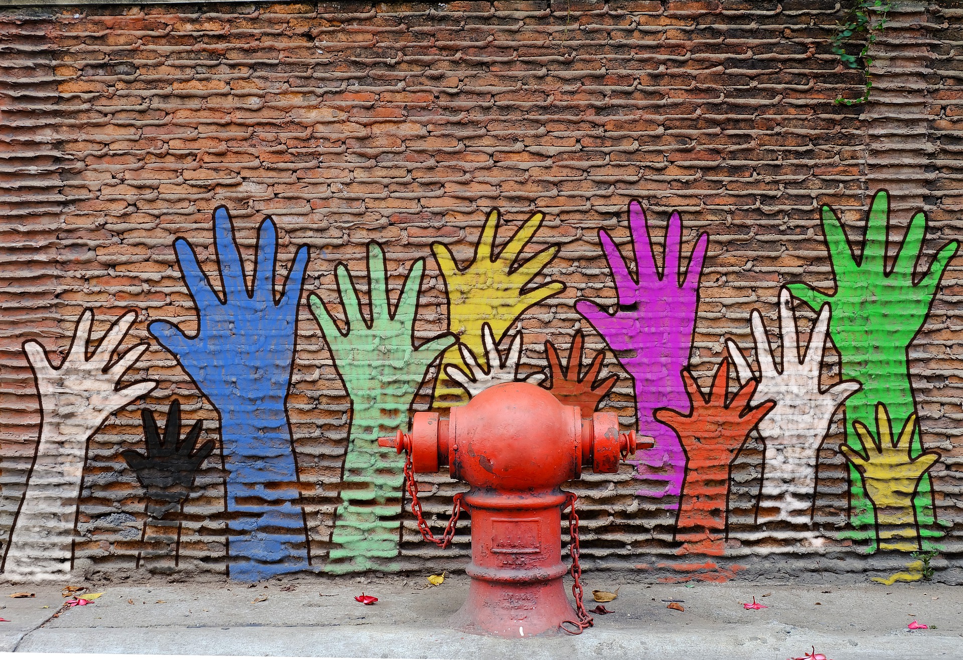 hand mural on brick wall
