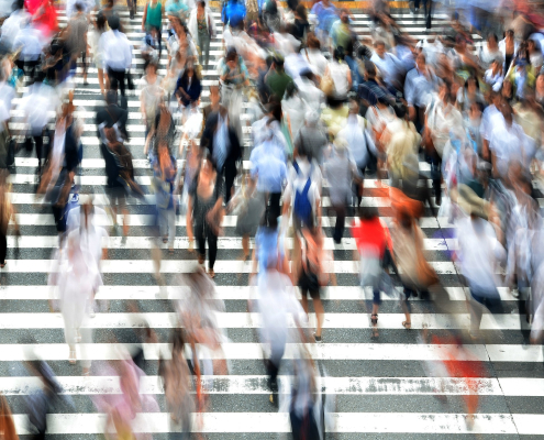 large amounts of pedestrians crossing wide crosswalk