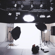 photography set up with white backdrop, lights, and camera equipment