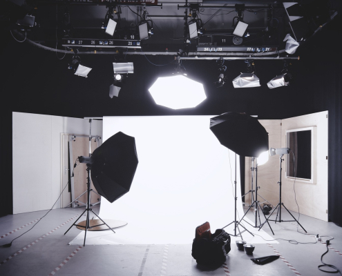 photography set up with white backdrop, lights, and camera equipment