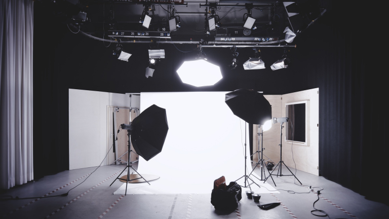 photography set up with white backdrop, lights, and camera equipment