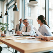 team working together smiling at conference table