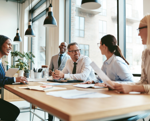 team working together smiling at conference table