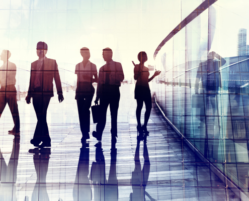 Silhouettes Of Business People Walking In The Office