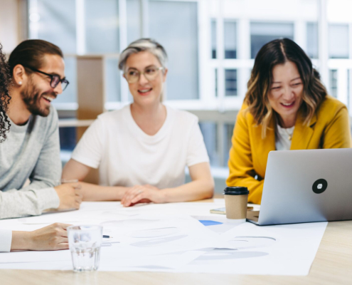 Cheerful Design Professionals Smiling Happily During A Meeting