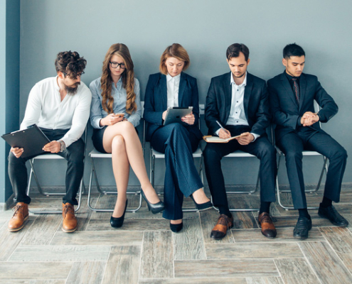 five business workers waiting for a job interview