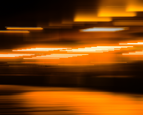 Abstract motion blur lights symbolizing speed, adaptability, and flexible legal resourcing used to manage changing workloads and operational demand in modern legal departments.