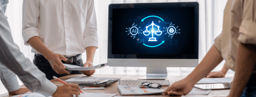 Three legal professionals standing around a desk reviewing documents while a computer screen displays an AI and justice scales graphic, representing the use of artificial intelligence in legal work.