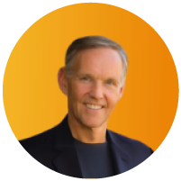 Portrait of Keith F., a smiling older man with gray hair in a dark sweater, in a circular orange-framed photo.