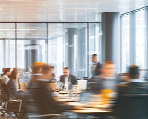 Busy startup office meeting showing a fast-moving team, representing on-demand legal counsel that scales with deal spikes, contracts, and fundraising needs.