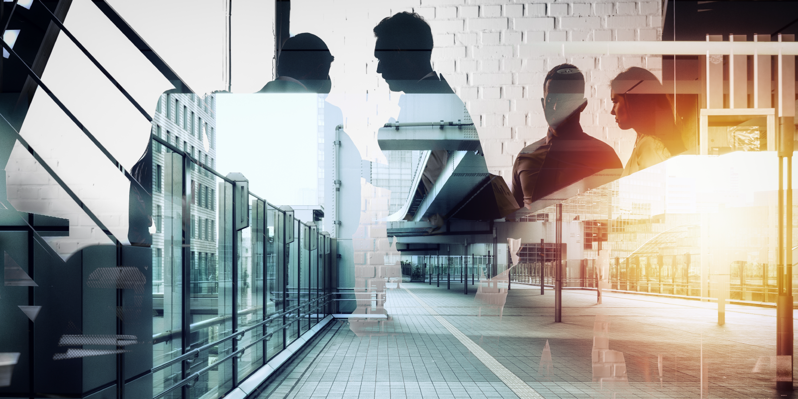 Double exposure image showing silhouettes of business professionals overlaid with a modern urban walkway and buildings, creating a layered corporate scene.