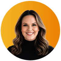 Headshot of Alisha Cieslak, a smiling woman with long dark wavy hair wearing a black turtleneck, set against an orange circular background.