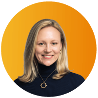 Headshot of Jenn Wall, General Counsel at Intrinsic, smiling with blonde hair, against an orange circular background.